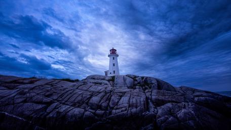 Peggy's Cove Lighthouse Beneath Dramatic Dusk Skies in Nova Scotia wallpaper