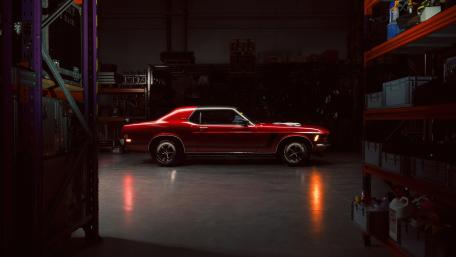 Red Mustang Muscle Icon in a Shadowy Garage Glow wallpaper
