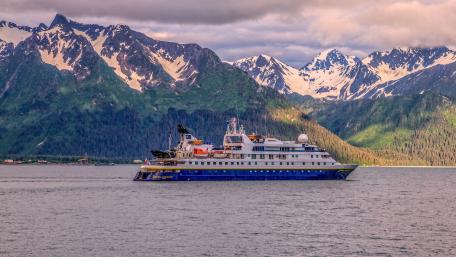 National Geographic Orion Expedition Ship Beneath Snowcapped Coastal Mountains wallpaper