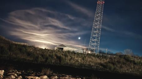 Moonlit Hill and Tower Under Moving Clouds wallpaper