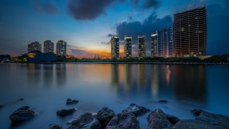 Jakarta Twilight Skyline Reflections Over Calm Water wallpaper