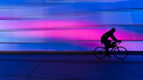 Neon Night Cycling Silhouette in 4K Motion Blur Glow wallpaper