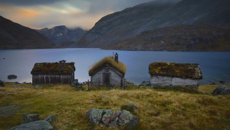 Turf Roof Huts by a Still Lake in Gaularfjellet Norway wallpaper
