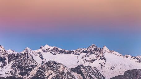 Pastel Dawn Over Snowy Alpine Ridge and Jagged Winter Summits wallpaper