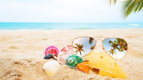 Sunlit Beach Escape Reflected in Sunglasses and Seashells wallpaper