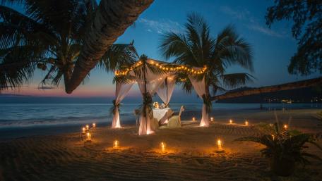 Candlelit Beach Dinner Under Palms at Twilight in Tropical Paradise wallpaper