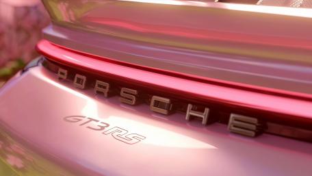 Sunlit Porsche GT3 RS Badge in Glossy Red Close Up wallpaper