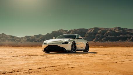 Aston Martin Vantage Supercar Poised on Desert Flats in 5K wallpaper