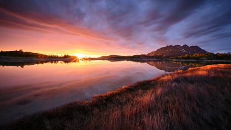 Midnight Sun Sunset Over Mirror Lake and Mountain Horizon wallpaper
