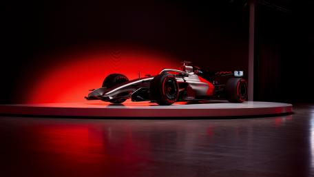 Audi Inspired Formula One Car Under Red Studio Lights wallpaper