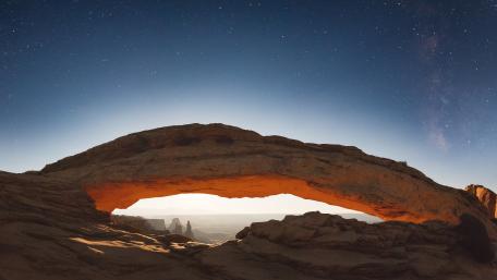 Starlit Mesa Arch Over Canyonlands Horizon in Moab Utah wallpaper