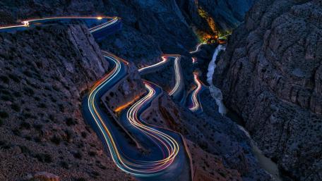 Serpentine Light Trails Through Dades Gorges at Dusk Morocco wallpaper