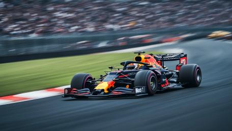 High Speed Formula Racing Through a Blurred Grandstand Sprint wallpaper