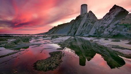 Sunset Reflections at Torre Del Guadalmesi Coastline in Cádiz Spain wallpaper