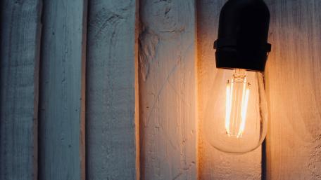 Warm Edison Glow on Rustic Planks in Technic Still Life 4K wallpaper