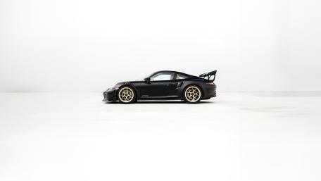 Minimalist Black Porsche 911 GT3 RS on Clean White Background wallpaper
