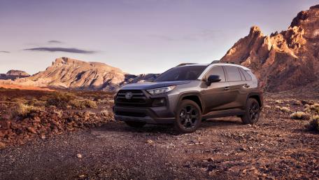 Toyota RAV4 SUV at Sunset in Rugged Desert Mountains wallpaper