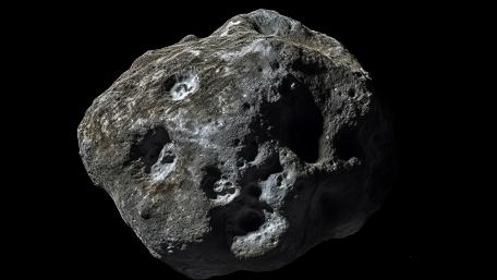 Lone Cratered Asteroid Drifting Through Silent Black Space wallpaper