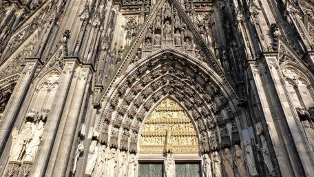 Gothic Grandeur at Cologne Cathedral Facade and Sacred Arch wallpaper