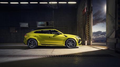 Lamborghini Urus in Neon Yellow Waiting at the Hangar Door wallpaper