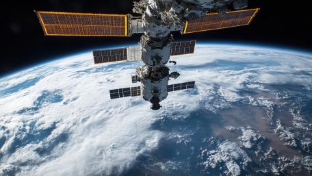 International Space Station Over Earths Blue Horizon wallpaper