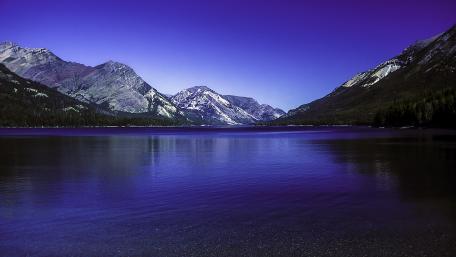 Twilight Reflections on Waterton Lakes Beneath Rugged Canadian Peaks wallpaper