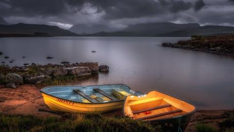 Moody Twilight Boats on Loch Migdale Shore in the Scottish Highlands wallpaper