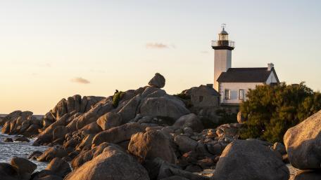 Golden Hour Calm at Pontusval Lighthouse on Brittanys Rocky Coast wallpaper
