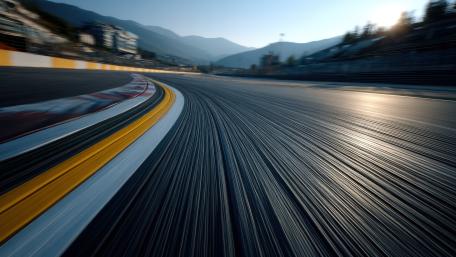 Sunlit Mountain Raceway Curve on High Speed Asphalt in 4K wallpaper