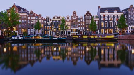 Twilight Reflections Along Amsterdam Canal Houses in the Netherlands wallpaper