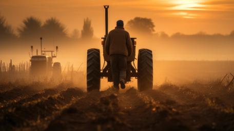 Dusk Harvest Run Farmworker Walking Toward Tractor in Golden Mist wallpaper