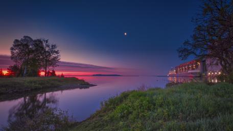 Tranquil Dawn Over Glassy Waters and Silent Shoreline wallpaper
