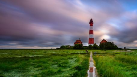 Westerheversand Lighthouse Over Windswept Grasslands in Northern Germany wallpaper