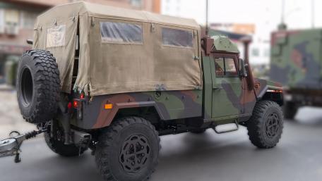 Camouflage Tactical Utility Vehicle in Urban Staging Area 5K Wallpaper wallpaper