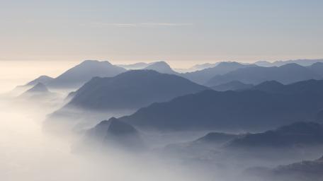Silent Mist Draped Mountain Range in Soft Morning Light wallpaper