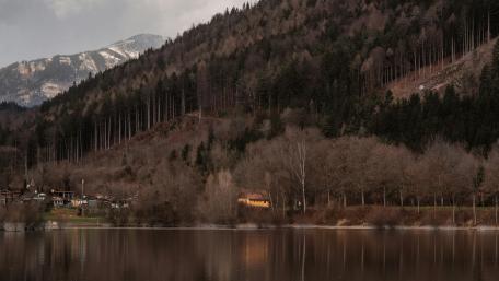Moody Mountain Lake Reflection Under Soft Overcast Skies wallpaper