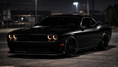 Midnight Dodge Challenger Muscle Car With Glowing Halo Headlights wallpaper