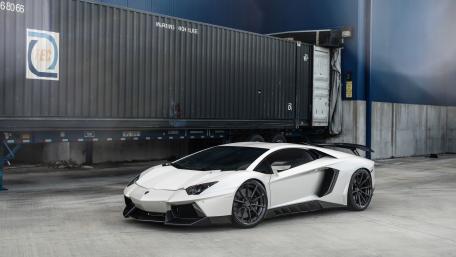White Lamborghini Aventador Supercar in Industrial Harbor Scene wallpaper