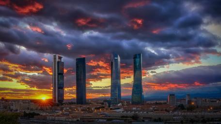 Sunset Over Madrid Cuatro Torres Skyline in Dramatic Cloudscape wallpaper
