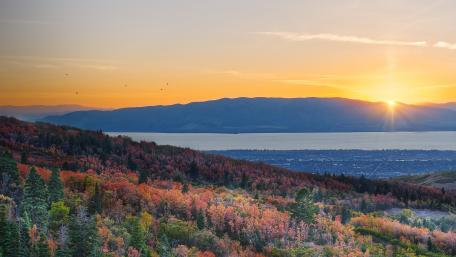 Golden Sunrise Over Autumn Hills and Lakeside Valley Panorama wallpaper