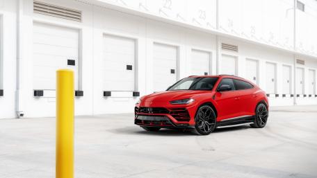 Red Lamborghini Urus in Minimalist Industrial Garage Setting wallpaper