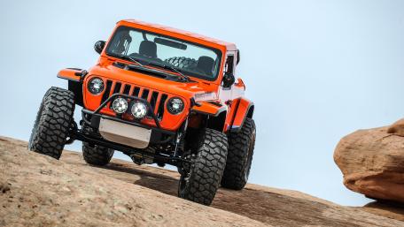 Jeep Sandstorm Conquering Rugged Rock Trails in Vibrant Orange wallpaper
