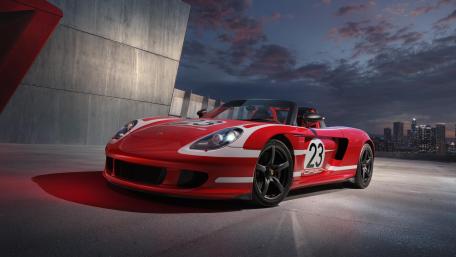 Red Porsche Carrera GT Racing Livery Under City Night Sky wallpaper