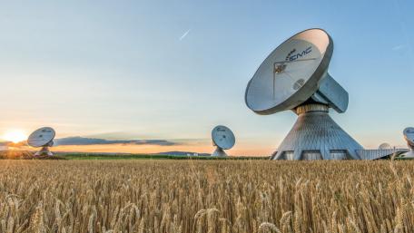 Radio Telescopes Rising Above Golden Wheat Fields at Sunset wallpaper