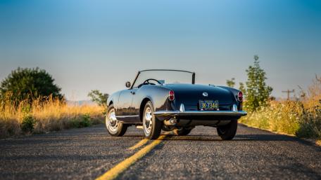 Alfa Romeo Giulietta Spider Cruising a Golden Country Road wallpaper