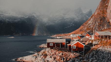Rainbow Over Lofoten Fjord and Red Cabins in Norway 4K wallpaper