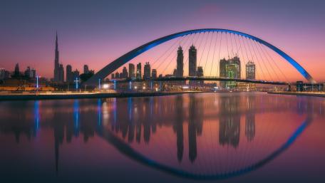 Twilight Reflections at Dubai Tolerance Bridge Over Still Waters wallpaper