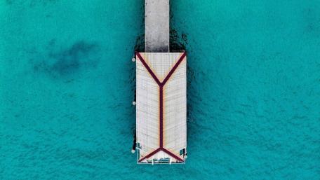 Overwater Bungalow Aerial Serenity Above Turquoise Sea wallpaper