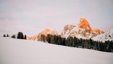Alpenglow Peak Above Silent Winter Pines in Crisp 5K wallpaper