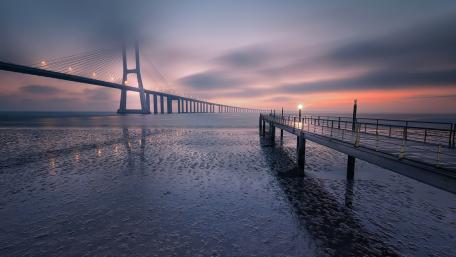 Vasco da Gama Bridge at Dawn Over Lisbon Waters wallpaper